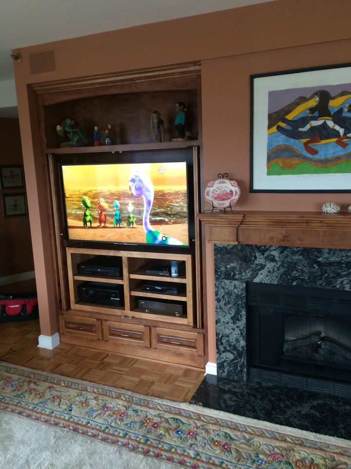 TV mounted above a sleek wooden media unit.