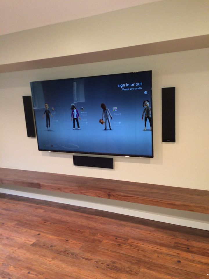 TV installation on a white, minimalist wall.